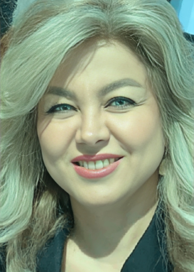 Woman with blonde wavy hair smiling at camera, professional headshot for orthodontics practice.